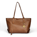 Woven faux leather tote bag in rich cognac brown. Wide shoulder handles, structured shape